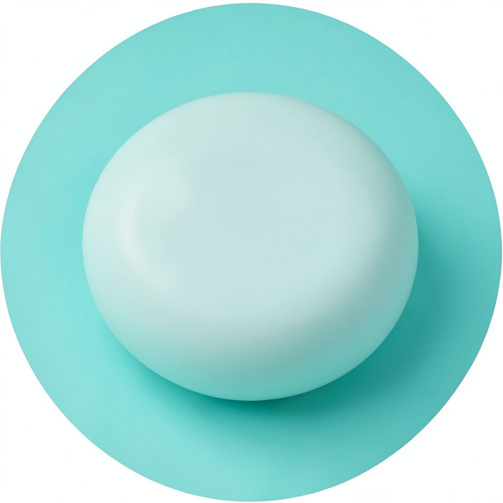 A circular studio photograph of a rounded object in soft mint against a pale background.